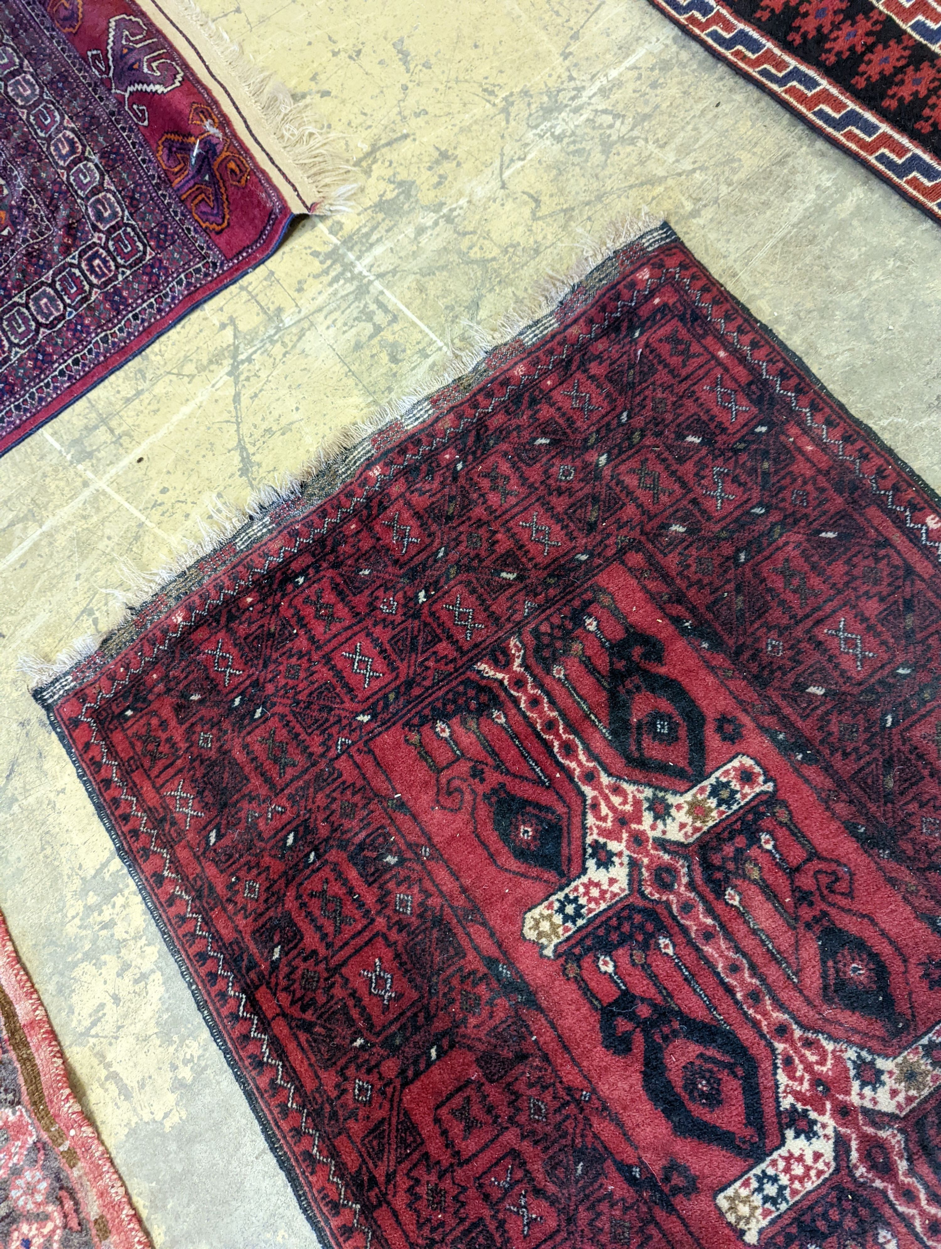 A Belouch red ground runner, 274 x 77cm